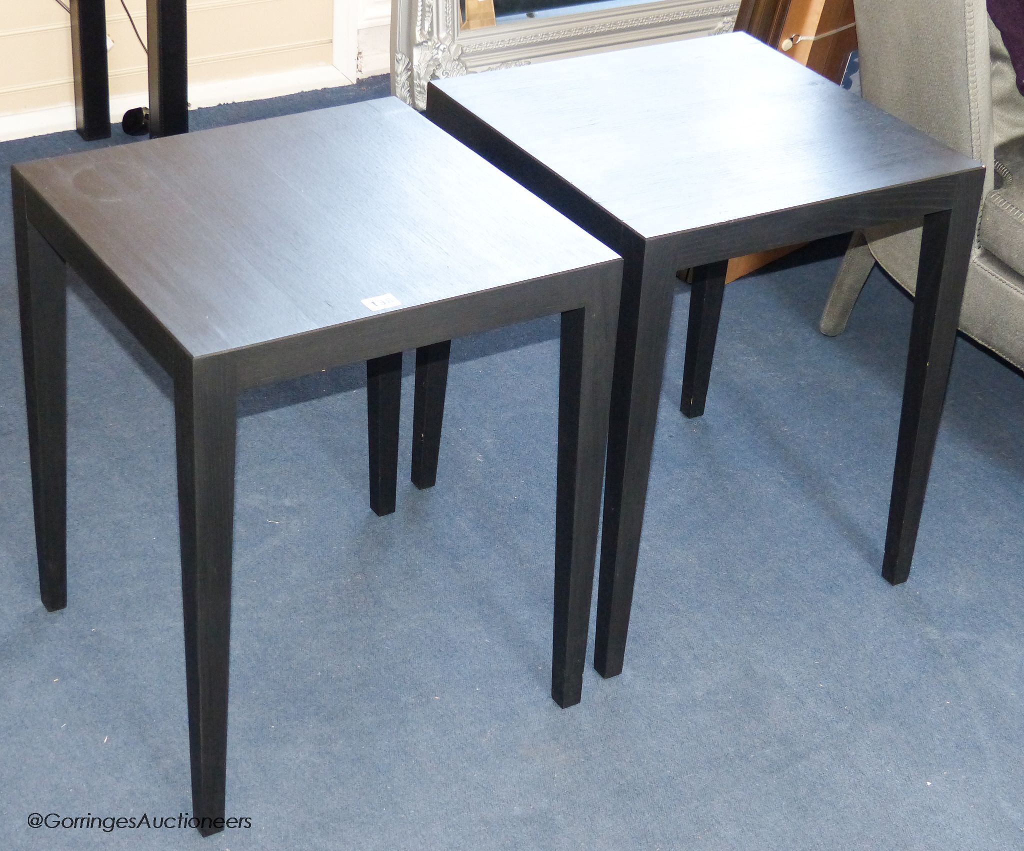 A pair of ebonised lamp tables, 45 cm wide, 55 cm high